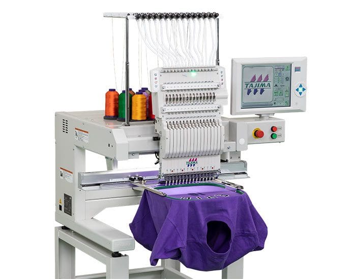 67c0a5dfa702f_TajimaTMEZ-SC-FF22 A machine with purple fabric hanging from it.