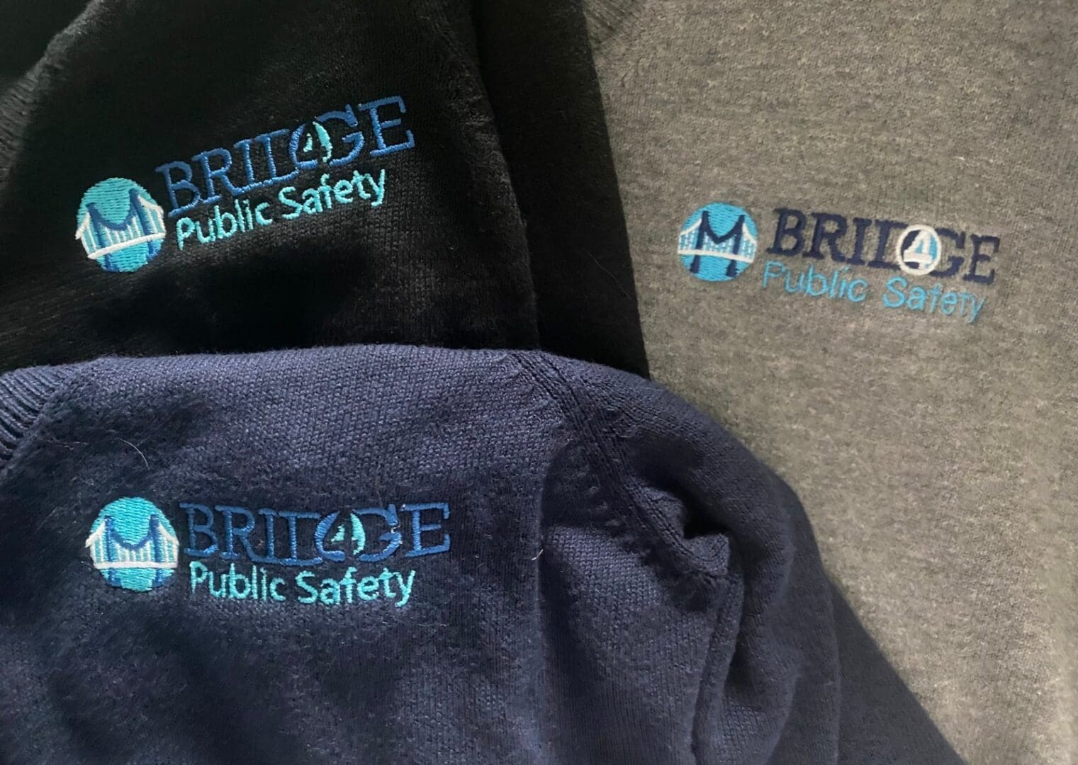 Company logo embroidered on work apparel for Bridge Public Safety by Embroidery By Shotzy in Houston