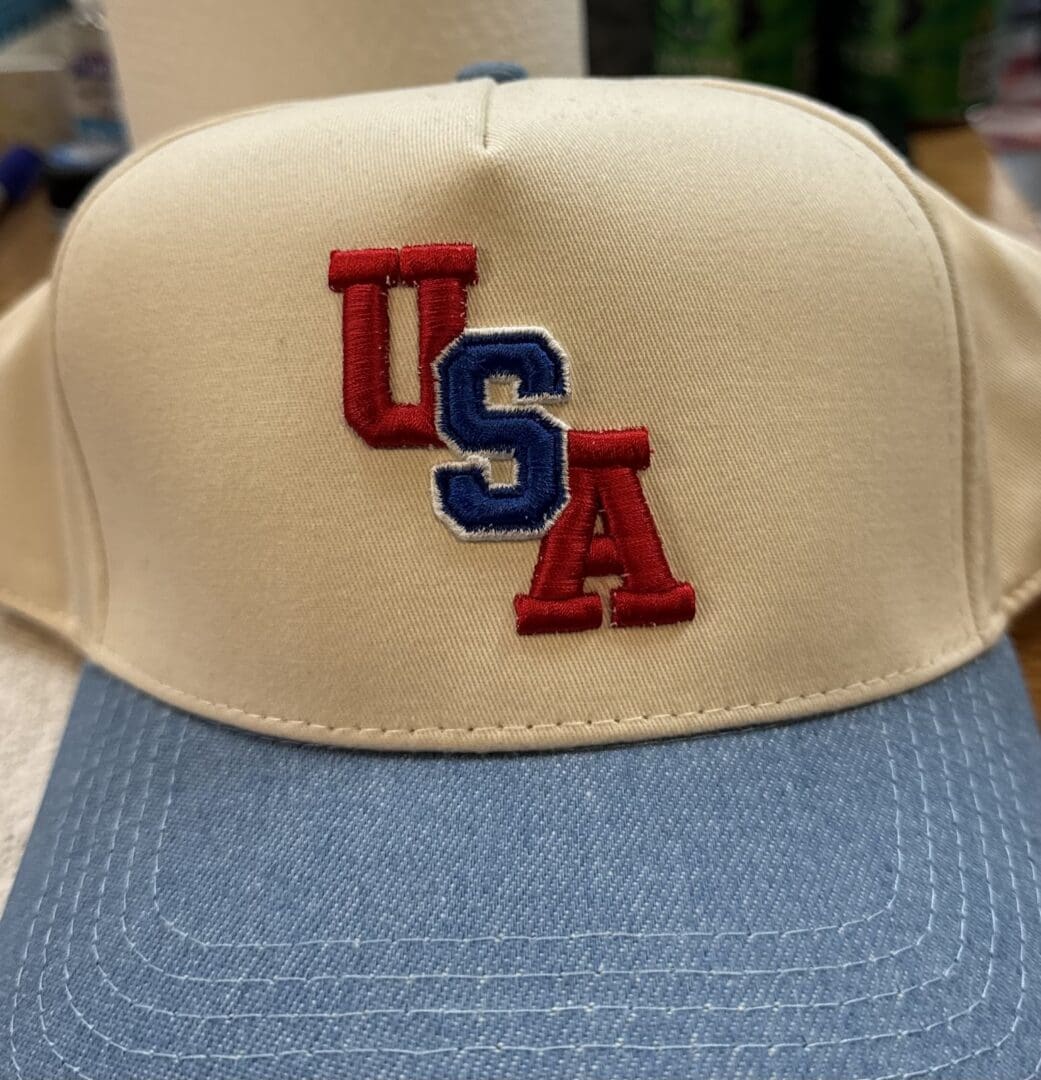 Cream and blue hat with USA in red, white and blue 3D puff embroidery